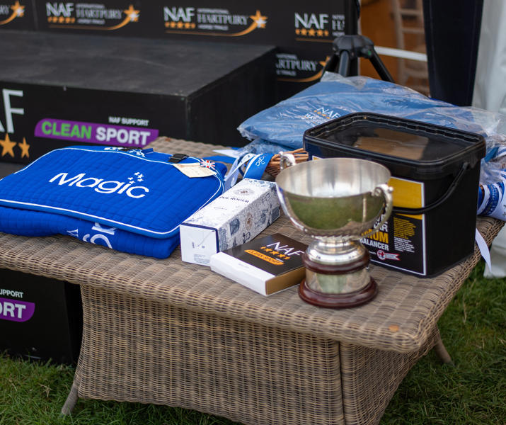 NAF Rugs And Trophy On Table