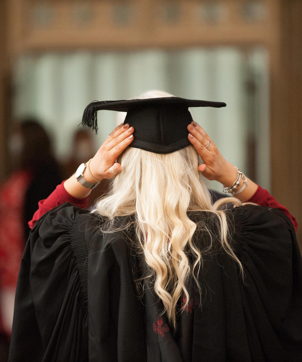 Graduation Female Student Adjusting Hat