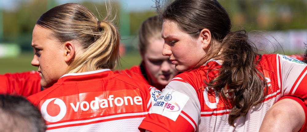 Women's Rugby Team In Huddle