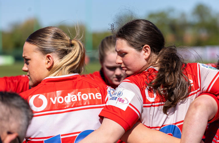 Women's Rugby Team In Huddle