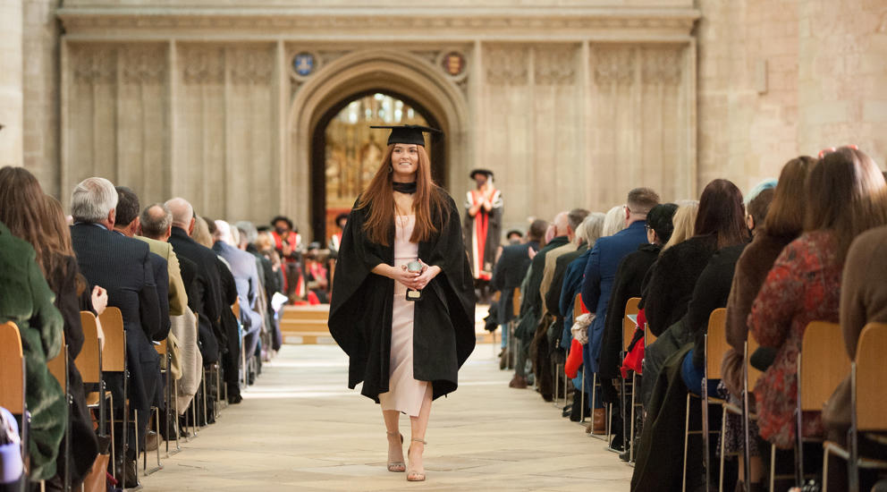 Female Graduating Student Walking Through Gloucester Cathedral