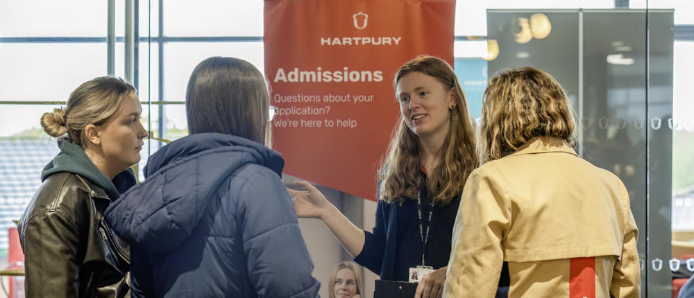 Admissions Staff Member Talking To Members Of The Public