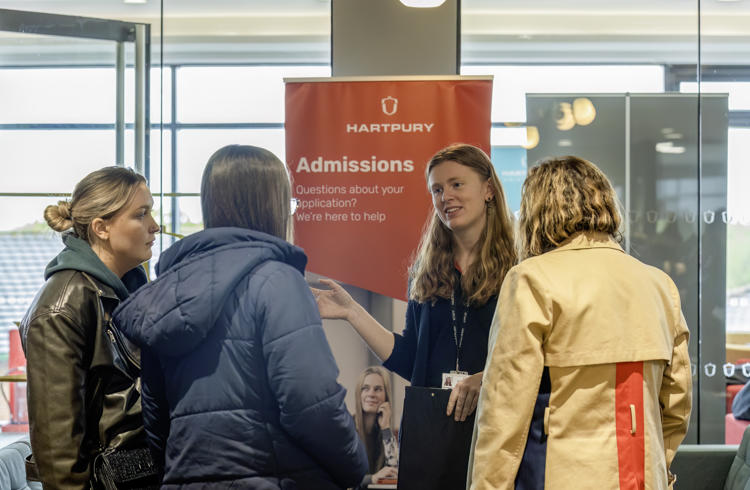 Admissions Staff Member Talking To Members Of The Public