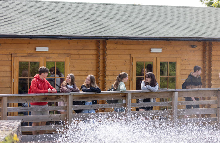 College Students Outside Cabin