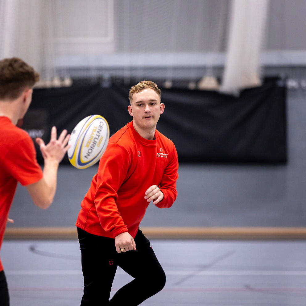 Two students taking part in sports coaching session