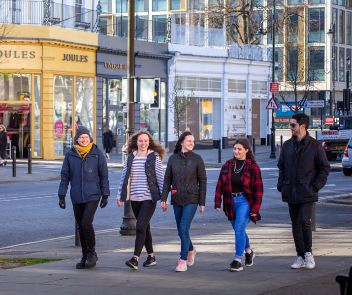 Students Walking Along Street In Cheltenham