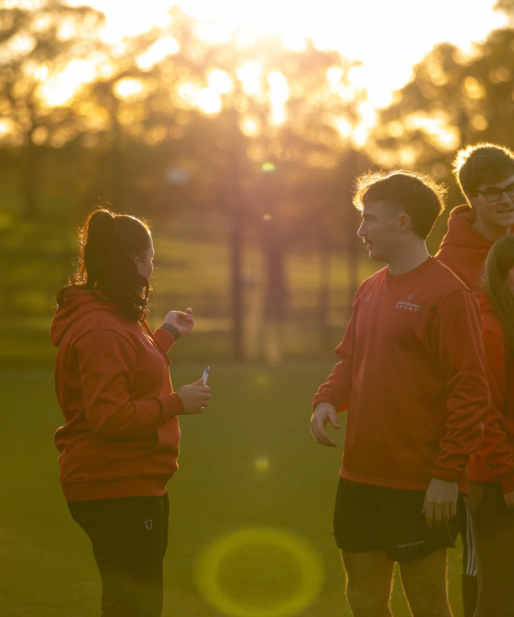 Group of sports students outside in setting sun