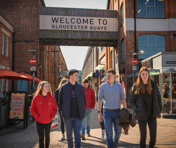 Group of students walking through Gloucester Quays