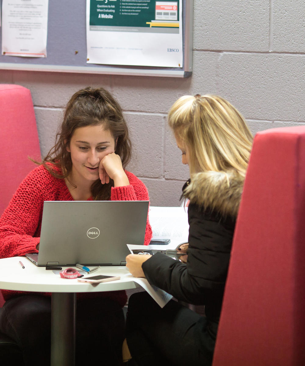 Two females students studying with laptop