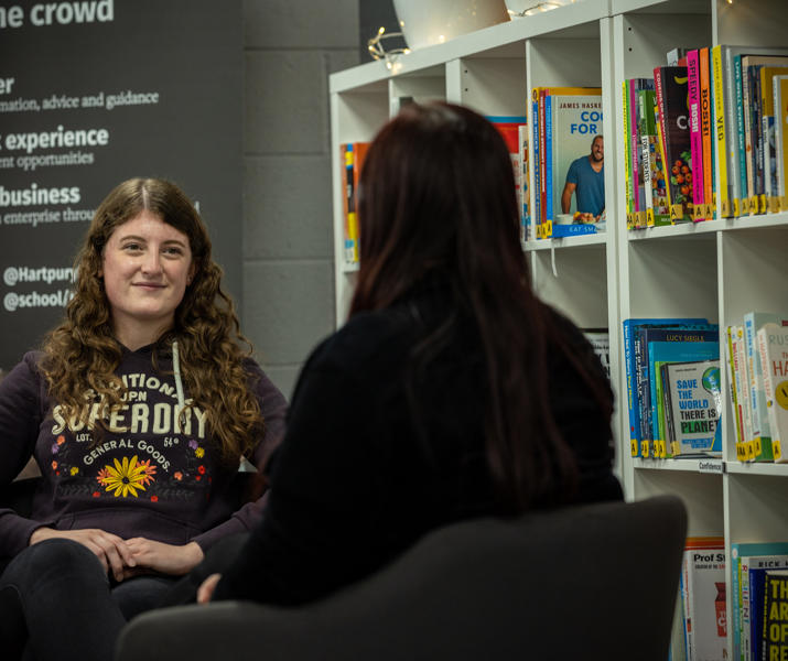 Student Support staff member sat opposite a student