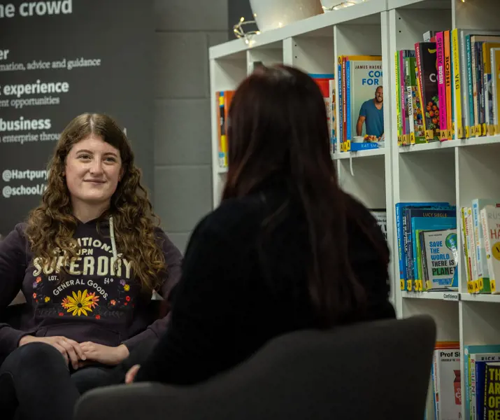 Student Support staff member sat opposite a student