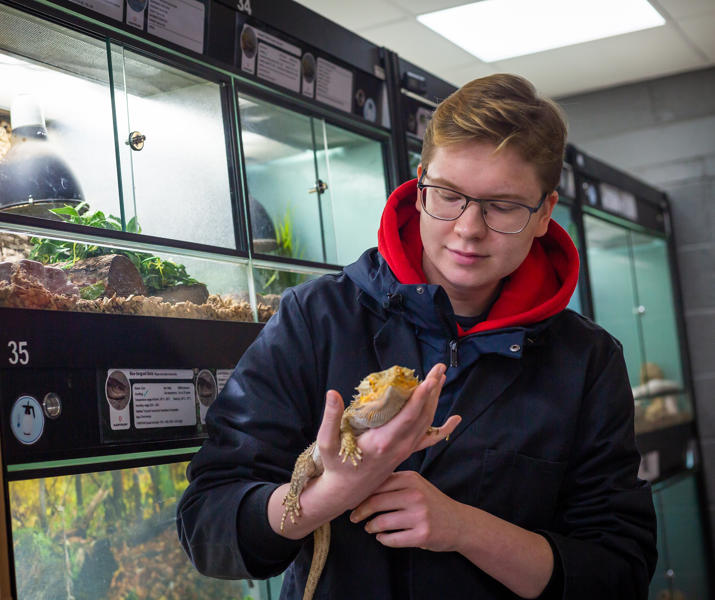 Male Student Holding Reptile